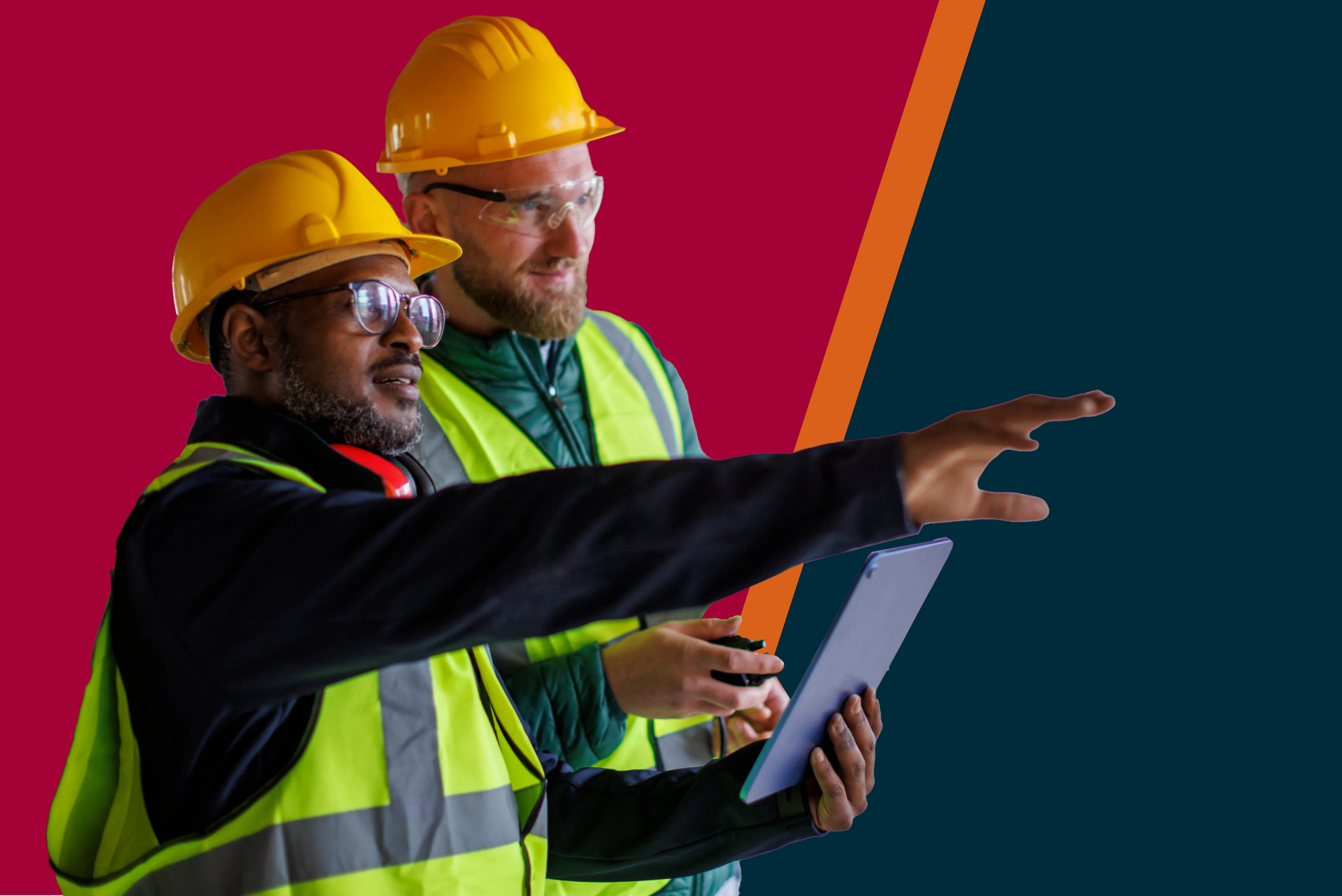 Two construction workers discuss work on a job site